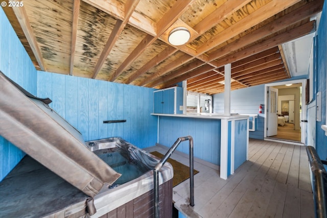 kitchen featuring a peninsula, hardwood / wood-style flooring, and blue cabinetry