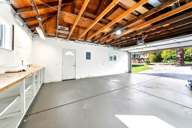 garage with electric panel and a garage door opener