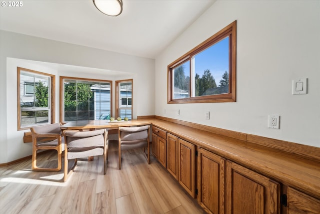 interior space featuring baseboards and light wood finished floors