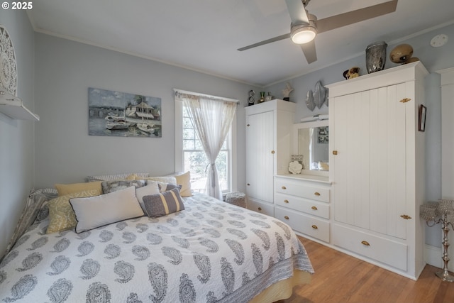 bedroom with crown molding, a ceiling fan, and wood finished floors