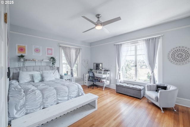 bedroom featuring ceiling fan, wood finished floors, and baseboards