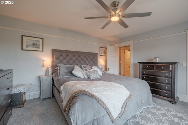 bedroom with a ceiling fan, light carpet, and baseboards