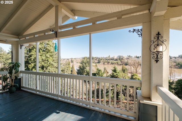 sunroom / solarium with lofted ceiling with beams