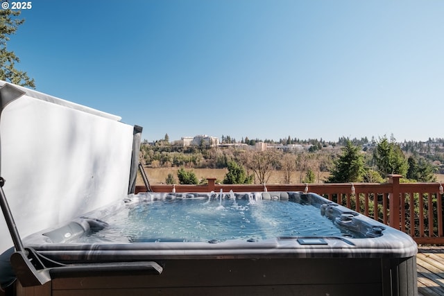 view of swimming pool featuring a wooden deck and a hot tub