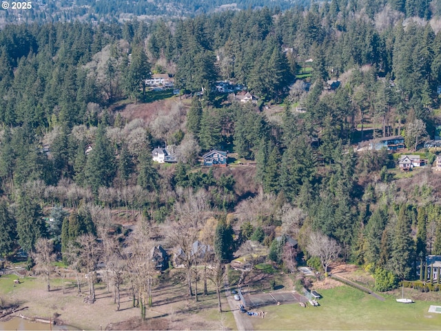 drone / aerial view featuring a view of trees