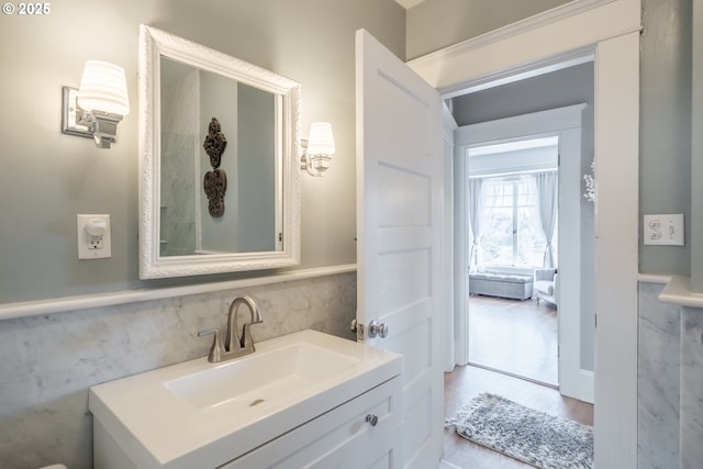 bathroom with a wainscoted wall and vanity