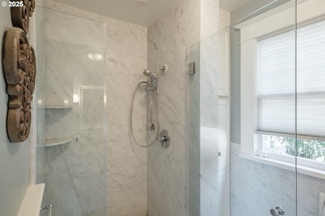 full bath featuring a marble finish shower