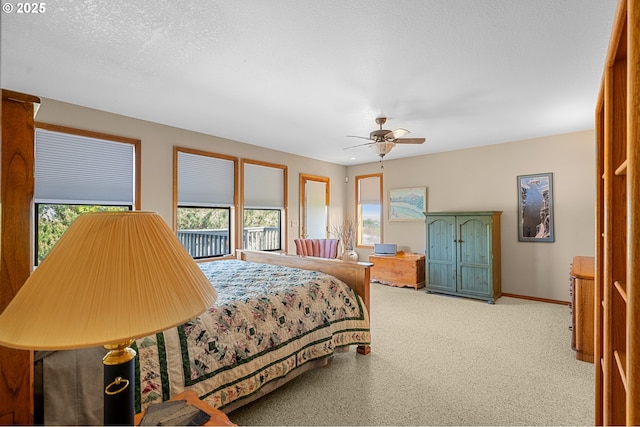carpeted bedroom featuring a ceiling fan, baseboards, and multiple windows