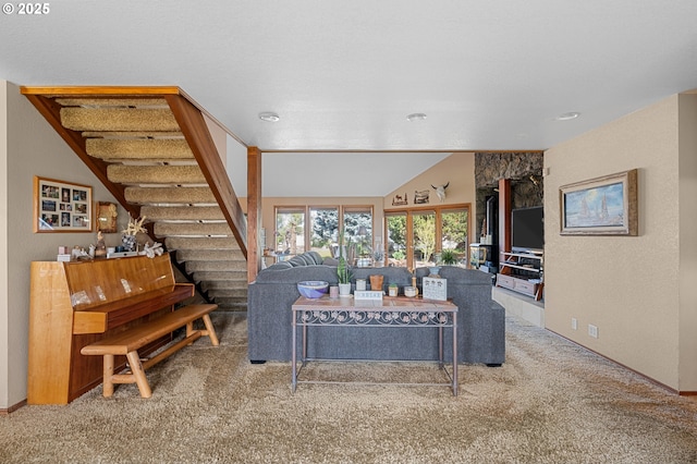 carpeted living room with baseboards, vaulted ceiling, and stairs