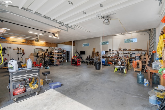 garage featuring a workshop area and a garage door opener