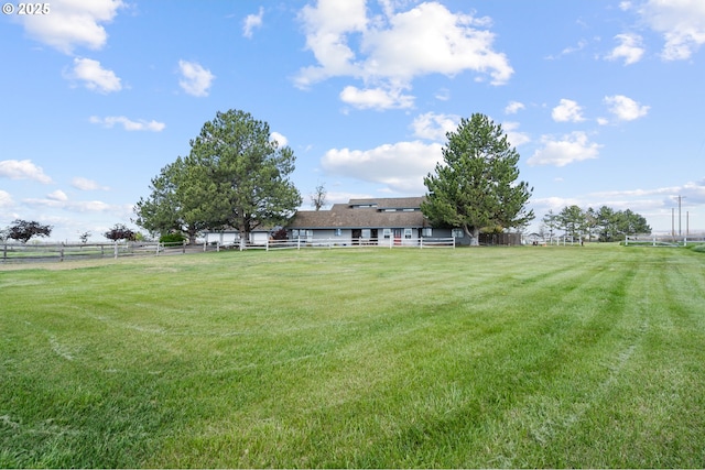 view of yard featuring a rural view and fence