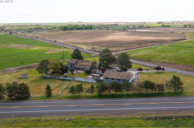 birds eye view of property with a rural view