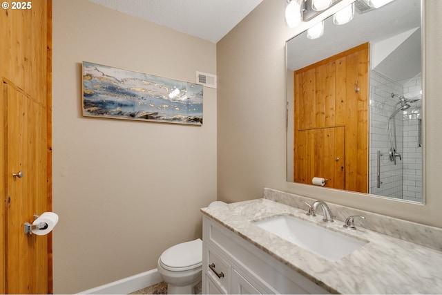 1626 NE Regatta Way, Lincoln City, OR 97367 - bathroom with vanity, toilet, a tile shower, and baseboards