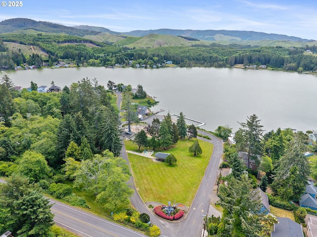 1626 NE Regatta Way, Lincoln City, OR 97367 - drone / aerial view of a water and mountain view and a heavily wooded area