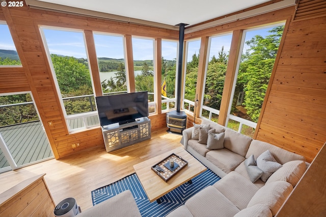 1626 NE Regatta Way, Lincoln City, OR 97367 - living area with wood finished floors, plenty of natural light, wood walls, and a wood stove