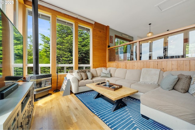 1626 NE Regatta Way, Lincoln City, OR 97367 - living area featuring light wood-type flooring, a wood stove, and wood walls