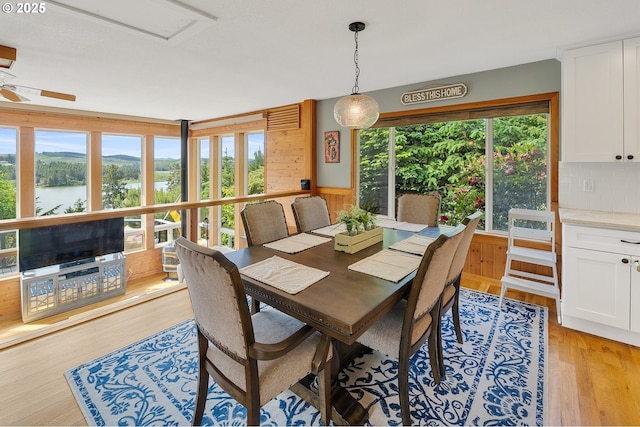 1626 NE Regatta Way, Lincoln City, OR 97367 - dining room with healthy amount of natural light, light wood-type flooring, and wood walls