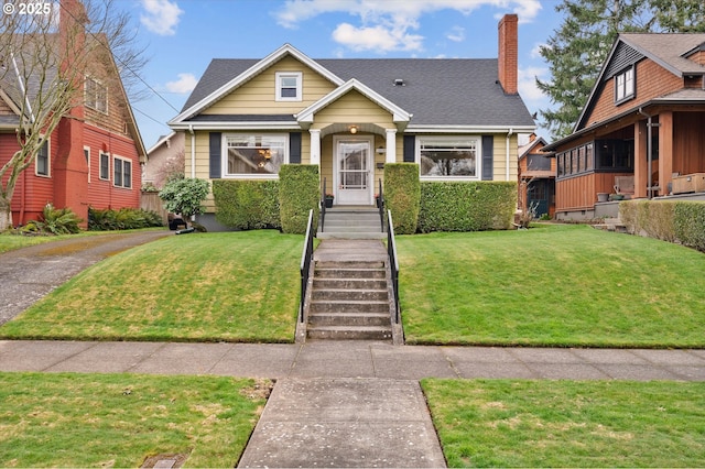 view of front of property with a chimney and a front yard