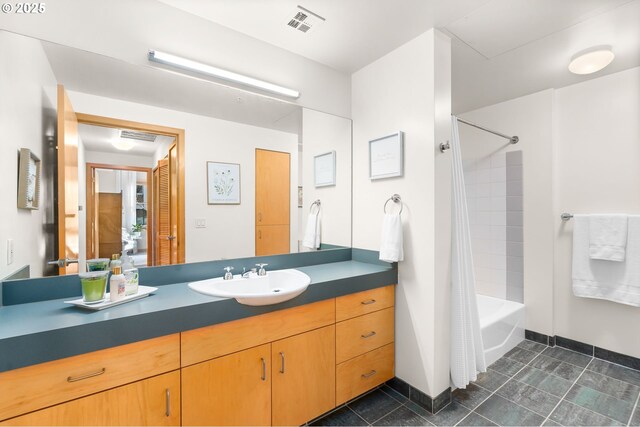 bathroom with vanity and shower / bath combo