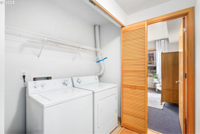 washroom featuring light colored carpet and washing machine and clothes dryer