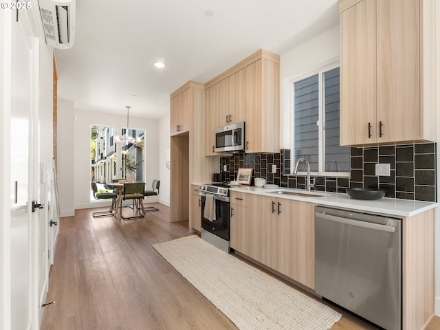 6020 NE Mason St Unit 9, Portland, OR 97218 - kitchen with stainless steel appliances, light brown cabinets, tasteful backsplash, and recessed lighting