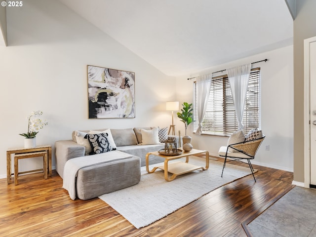 living room featuring light wood-type flooring and lofted ceiling