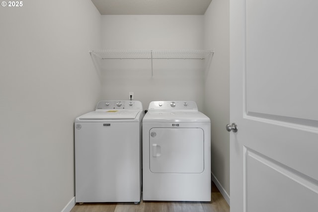 washroom featuring washer and dryer and light hardwood / wood-style flooring