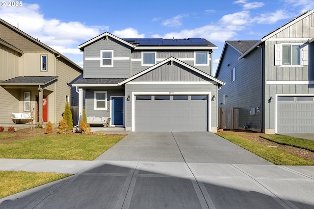 view of front of house featuring a garage, a front yard, and solar panels