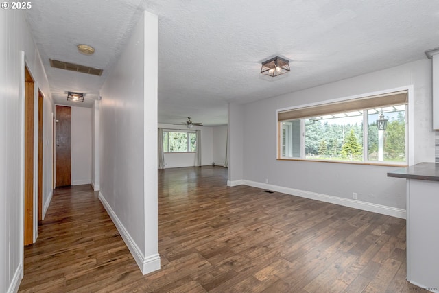 35538 SE Snuffin Rd, Estacada, OR 97023 - corridor with dark wood finished floors, a textured ceiling, and baseboards