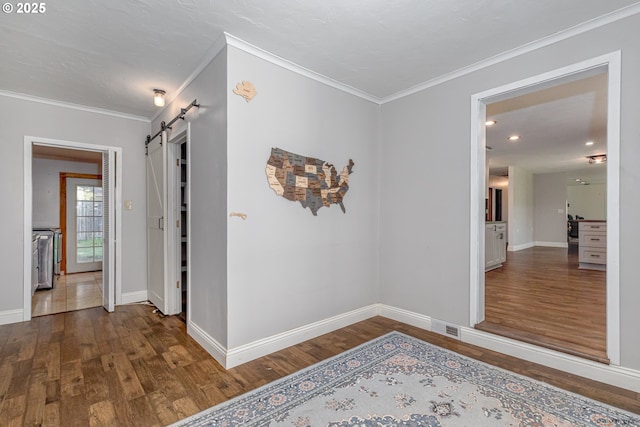 35538 SE Snuffin Rd, Estacada, OR 97023 - hallway with crown molding, wood finished floors, baseboards, a barn door, and recessed lighting