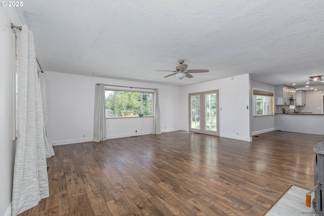 35538 SE Snuffin Rd, Estacada, OR 97023 - unfurnished living room featuring a ceiling fan, dark wood-type flooring, a textured ceiling, and baseboards