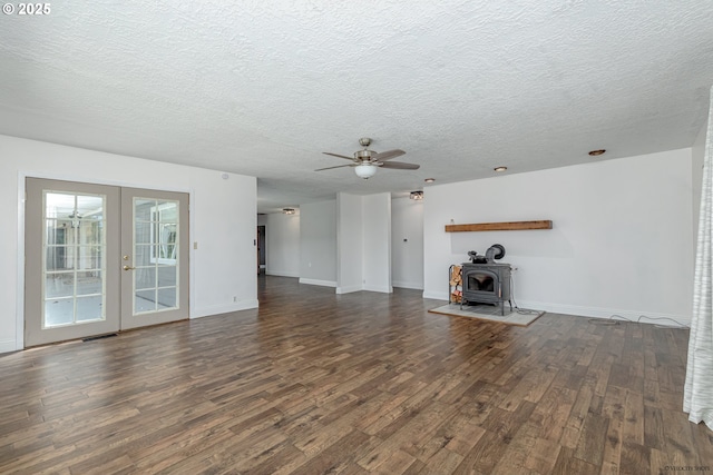 35538 SE Snuffin Rd, Estacada, OR 97023 - unfurnished living room with dark wood-style floors, french doors, a ceiling fan, a wood stove, and a textured ceiling