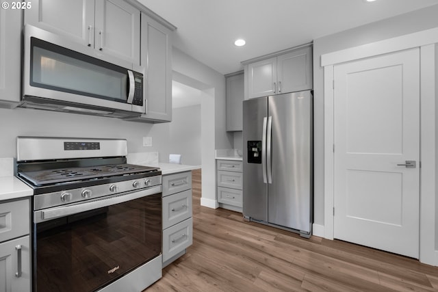 35681 Bella Ridge Loop, Astoria, OR 97103 - kitchen featuring stainless steel appliances, gray cabinetry, recessed lighting, light wood-style floors, and light countertops