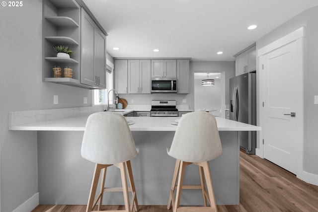 35681 Bella Ridge Loop, Astoria, OR 97103 - kitchen with stainless steel appliances, gray cabinetry, a peninsula, open shelves, and recessed lighting