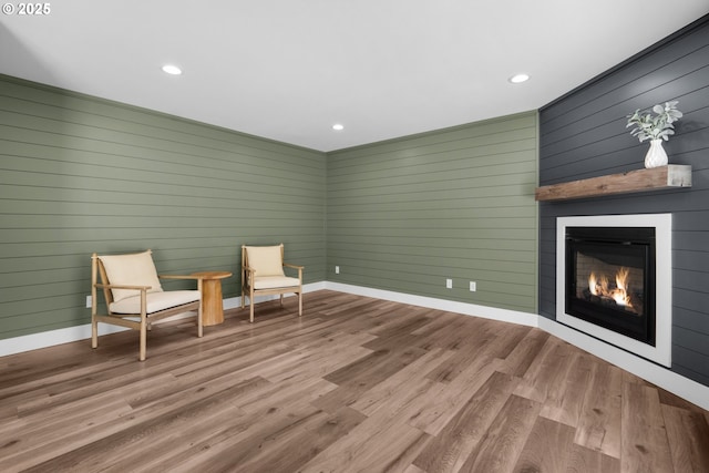35681 Bella Ridge Loop, Astoria, OR 97103 - unfurnished room featuring a fireplace, recessed lighting, wood finished floors, baseboards, and wood walls