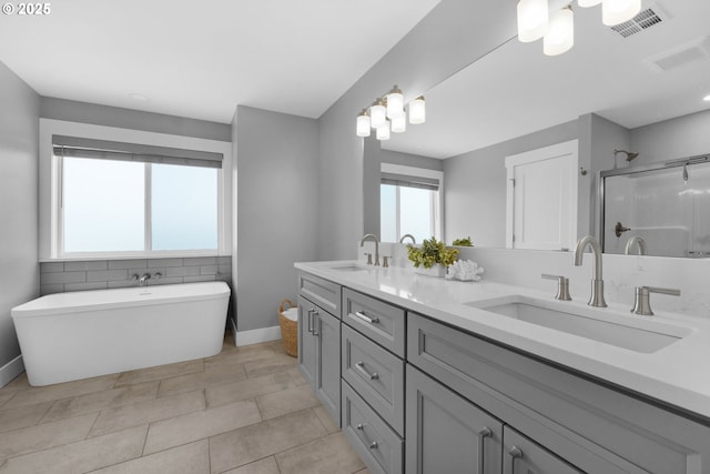 35681 Bella Ridge Loop, Astoria, OR 97103 - full bathroom with a shower stall, a freestanding bath, baseboards, double vanity, and tile patterned floors