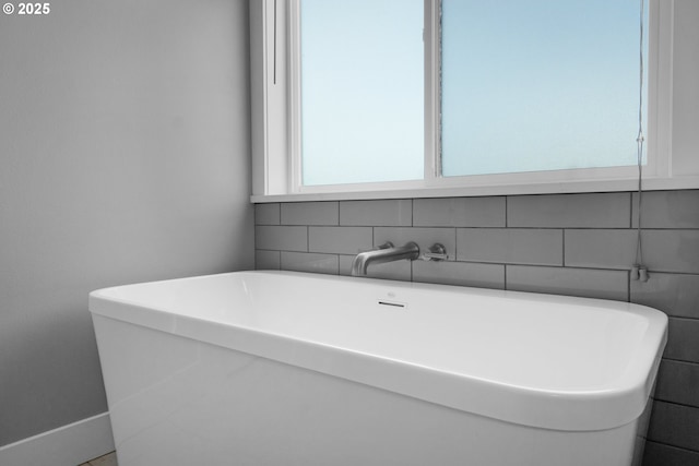 35681 Bella Ridge Loop, Astoria, OR 97103 - bathroom featuring a soaking tub and decorative backsplash