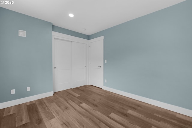 35681 Bella Ridge Loop, Astoria, OR 97103 - unfurnished bedroom with baseboards, wood finished floors, recessed lighting, and a closet
