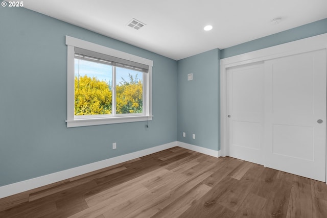 35681 Bella Ridge Loop, Astoria, OR 97103 - unfurnished bedroom with wood finished floors, baseboards, a closet, and recessed lighting