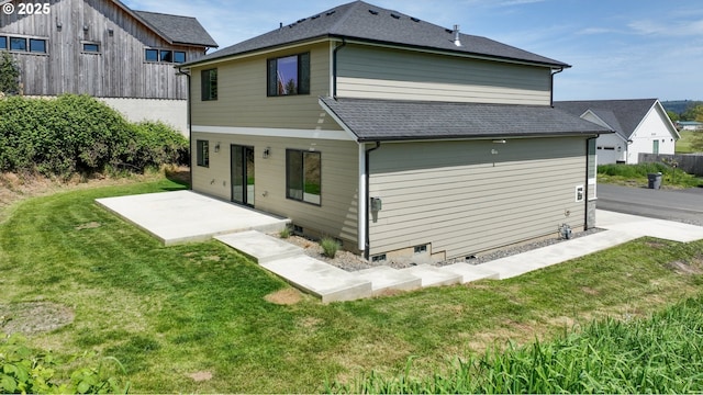 35681 Bella Ridge Loop, Astoria, OR 97103 - rear view of house featuring a patio area, a yard, and a shingled roof