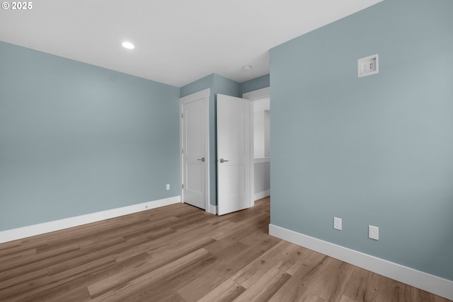 35681 Bella Ridge Loop, Astoria, OR 97103 - unfurnished bedroom with baseboards, wood finished floors, and recessed lighting