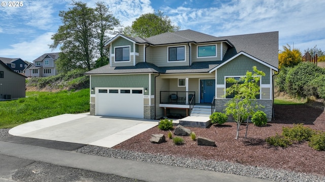 35681 Bella Ridge Loop, Astoria, OR 97103 - craftsman inspired home featuring a porch, an attached garage, driveway, stone siding, and roof with shingles