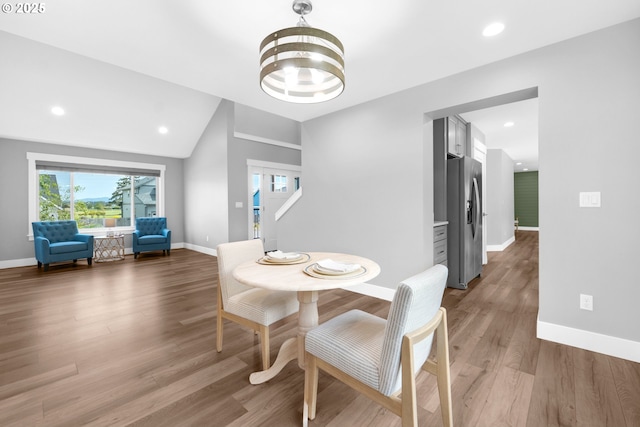 35681 Bella Ridge Loop, Astoria, OR 97103 - dining room with vaulted ceiling, baseboards, wood finished floors, recessed lighting, and a chandelier