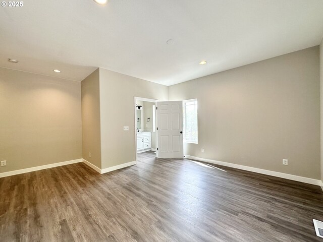 empty room featuring recessed lighting, visible vents, baseboards, and wood finished floors