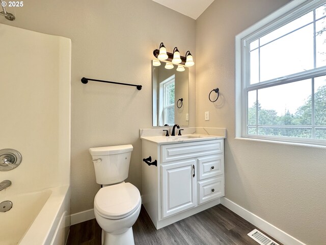 bathroom featuring vanity, wood finished floors, and baseboards