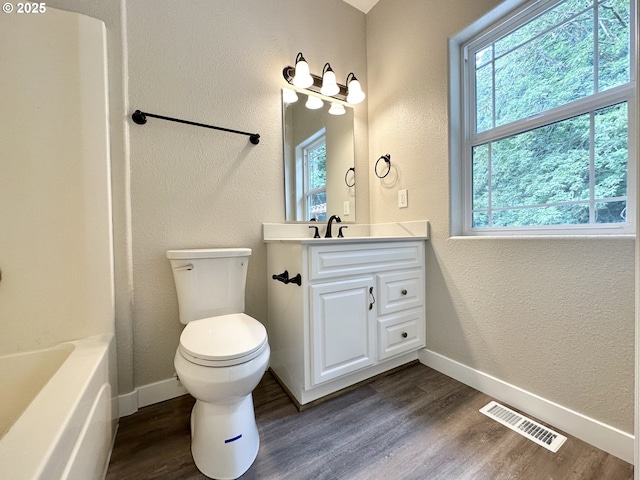 full bath featuring visible vents, baseboards, and wood finished floors