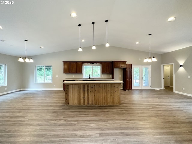 kitchen featuring a sink, open floor plan, a chandelier, and light countertops