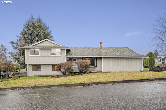 tri-level home with a front lawn