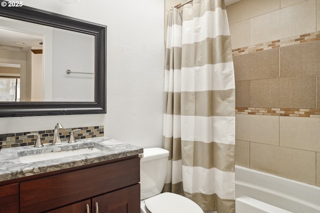 full bathroom featuring tasteful backsplash, vanity, toilet, and shower / bath combo