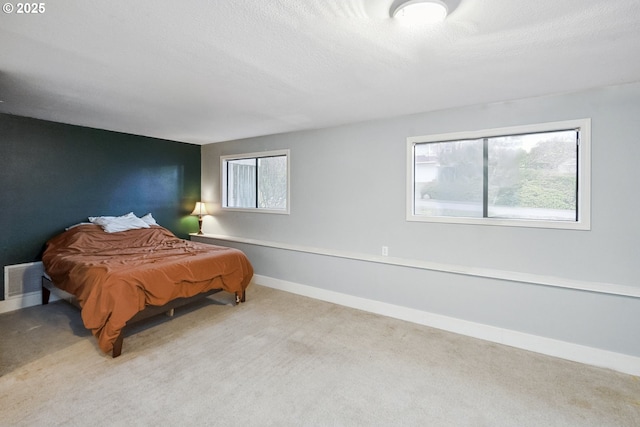 bedroom featuring carpet floors and a textured ceiling